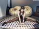 A woman sitting on the floor in front of a giant donut.