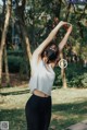 A woman wearing a face mask in a park.