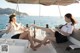 A couple of women sitting on top of a boat.