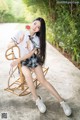 A woman sitting on a rocking chair holding a watermelon.