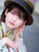 A woman wearing a hat is posing for a picture.